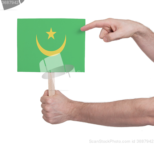 Image of Hand holding small card - Flag of Mauritania