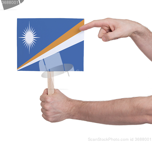 Image of Hand holding small card - Flag of Marshall Islands