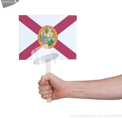 Image of Hand holding small card - Flag of Florida