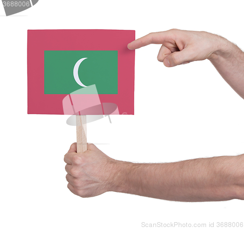 Image of Hand holding small card - Flag of Maldives