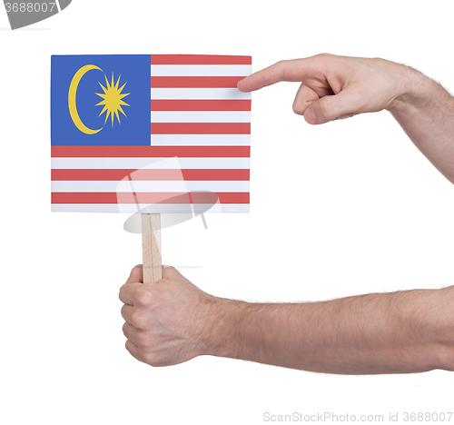 Image of Hand holding small card - Flag of Malaysia