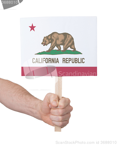 Image of Hand holding small card - Flag of California