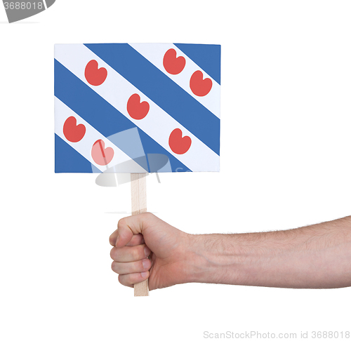 Image of Hand holding small card - Flag of Friesland