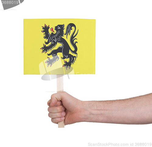 Image of Hand holding small card - Flag of Flanders