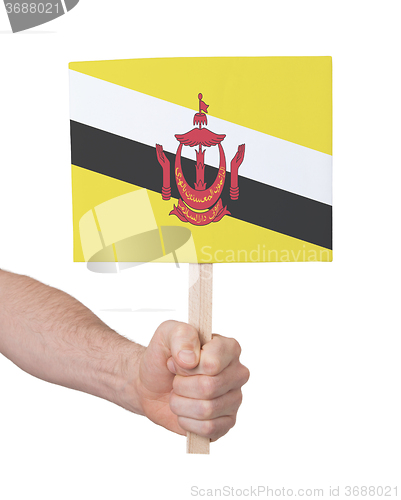 Image of Hand holding small card - Flag of Brunei