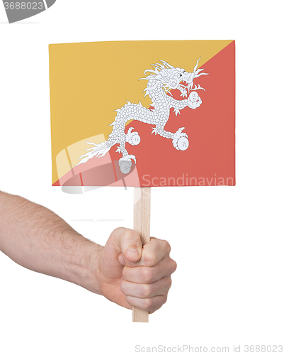 Image of Hand holding small card - Flag of Bhutan