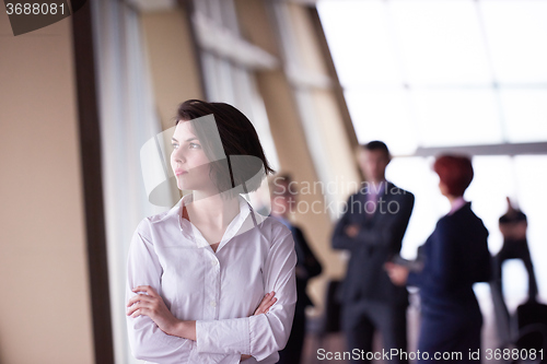 Image of business people group, woman in front  as team leader