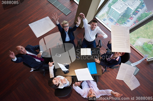 Image of top view of business people group throwing dociments in air