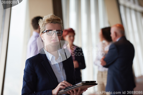 Image of diverse business people group with blonde  woman in front