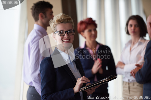 Image of diverse business people group with blonde  woman in front