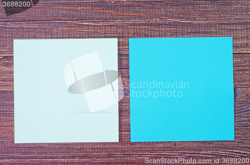 Image of color paper on wooden background