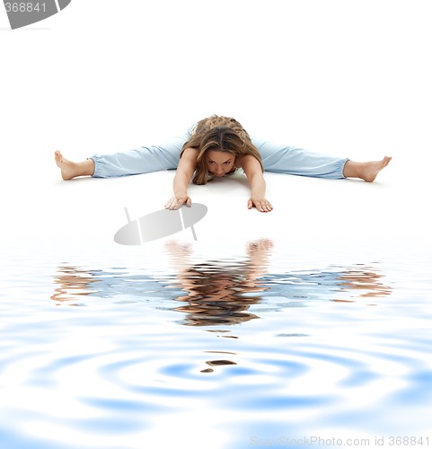 Image of upavistha konasana wide-angle seated forward bend on white sand