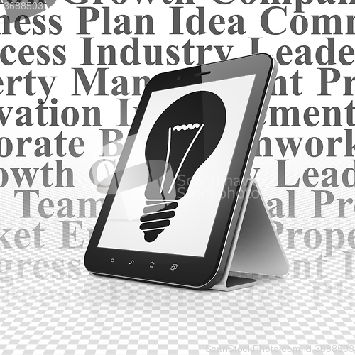 Image of Finance concept: Tablet Computer with Light Bulb on display