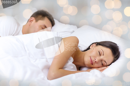 Image of happy couple sleeping in bed