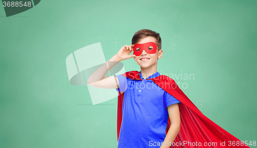 Image of boy in red superhero cape and mask