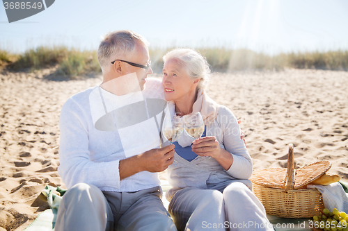 Image of happy senior couple talking on summer beach