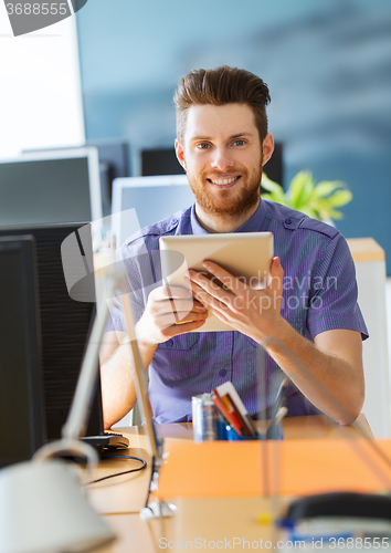 Image of happy creative male office worker with tablet pc