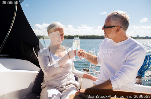 Image of senior couple clinking glasses on boat or yacht