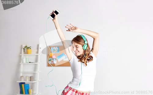 Image of happy woman in headphones ihaving fun at home