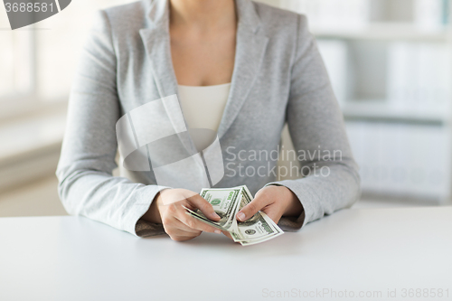 Image of close up of woman hands counting us dollar money