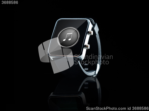 Image of close up of black smart watch with music note icon