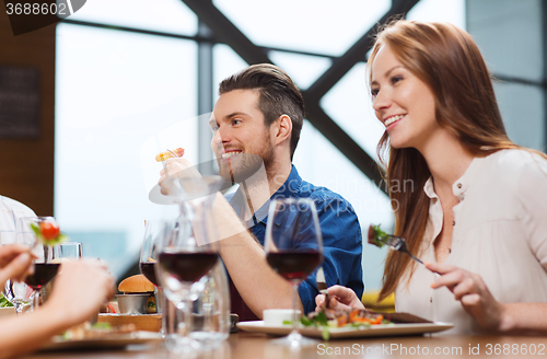 Image of happy couple having dinner at restaurant