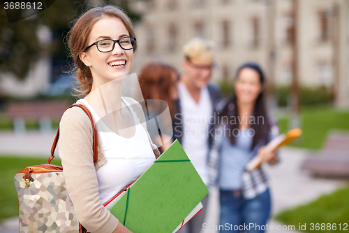 Image of happy teenage students with school folders