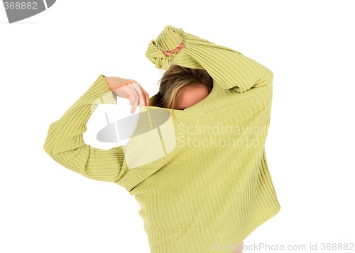 Image of Funny girl takes off a green sweater