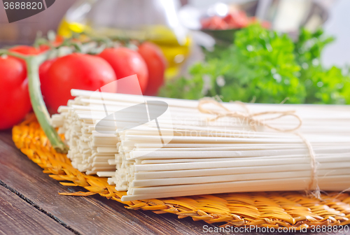 Image of raw pasta and  tomato and sauce