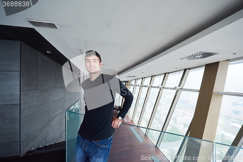 Image of young successful man in penthouse apartment