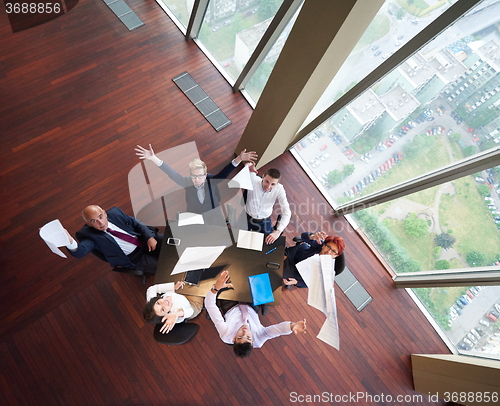 Image of top view of business people group throwing dociments in air