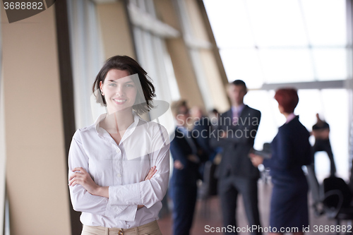 Image of business people group, woman in front  as team leader