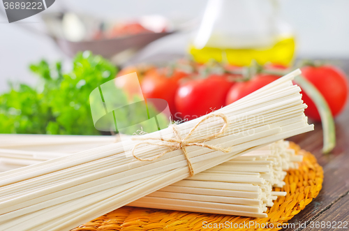 Image of raw pasta and  tomato and sauce