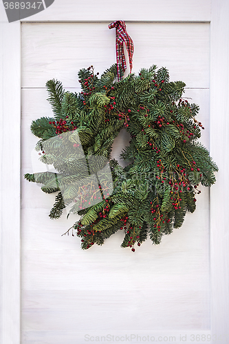 Image of Christmas wreath hanging on door