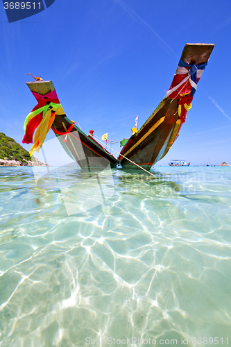 Image of    bay isle white  beach    rocks pirogue  in thailand  