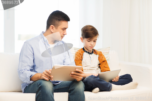 Image of father and son with tablet pc at home