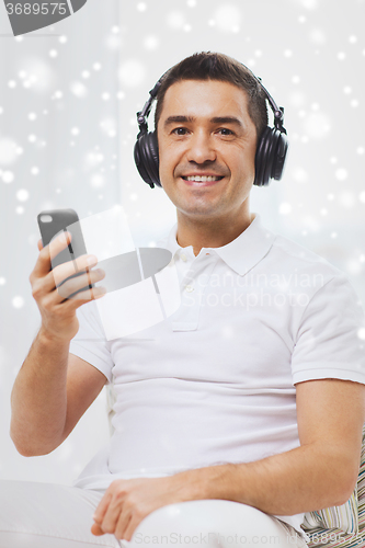 Image of happy man with smartphone and headphones