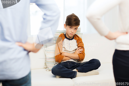 Image of upset or feeling guilty boy and parents at home