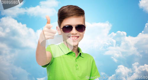 Image of smiling boy in sunglasses and green polo t-shirt