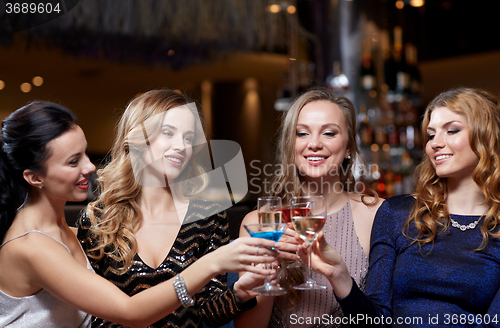 Image of happy women with drinks at night club