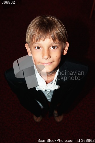 Image of young boy dressed to serve