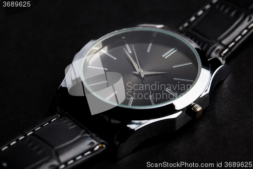 Image of close up of black classic male wristwatch