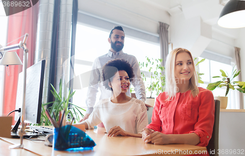Image of happy creative team in office