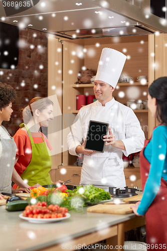 Image of happy women with chef and tablet pc in kitchen