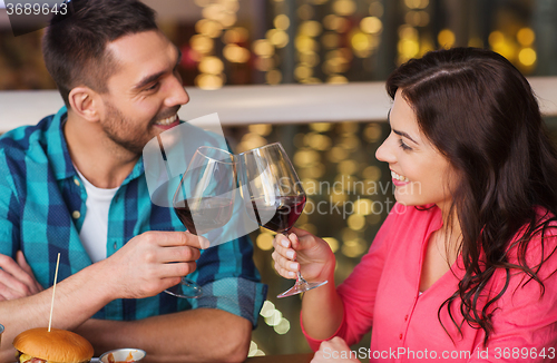 Image of happy couple dining and drink wine at restaurant