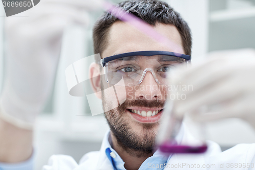 Image of young scientist making test or research in lab