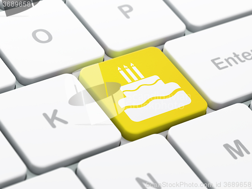 Image of Holiday concept: Cake on computer keyboard background