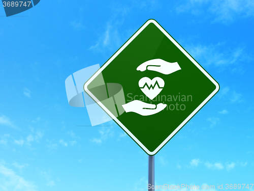 Image of Insurance concept: Heart And Palm on road sign background