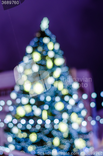 Image of Decorated Christmas tree. Blurred lights background