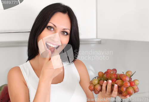 Image of woman eating grapes